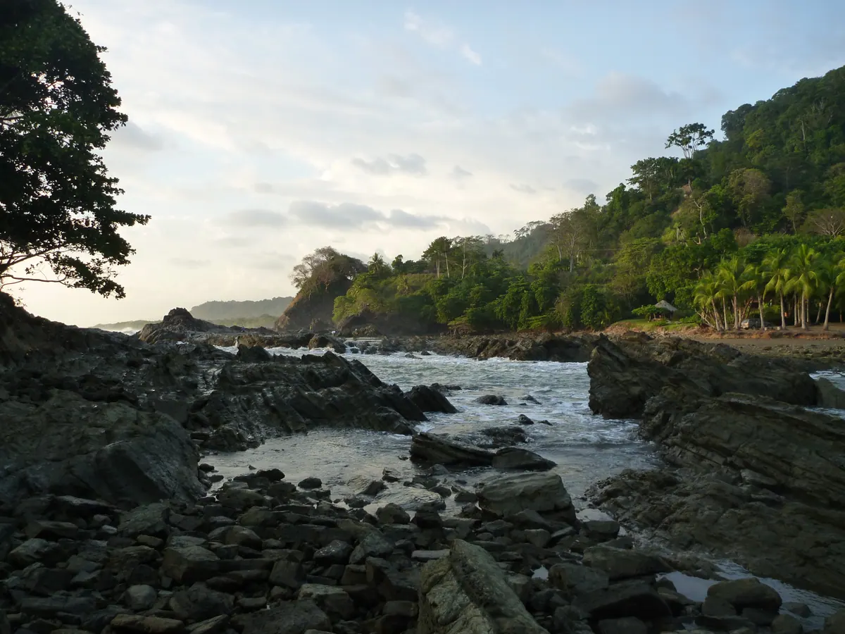 A rocky tropical cove beneath the forest near Dominical