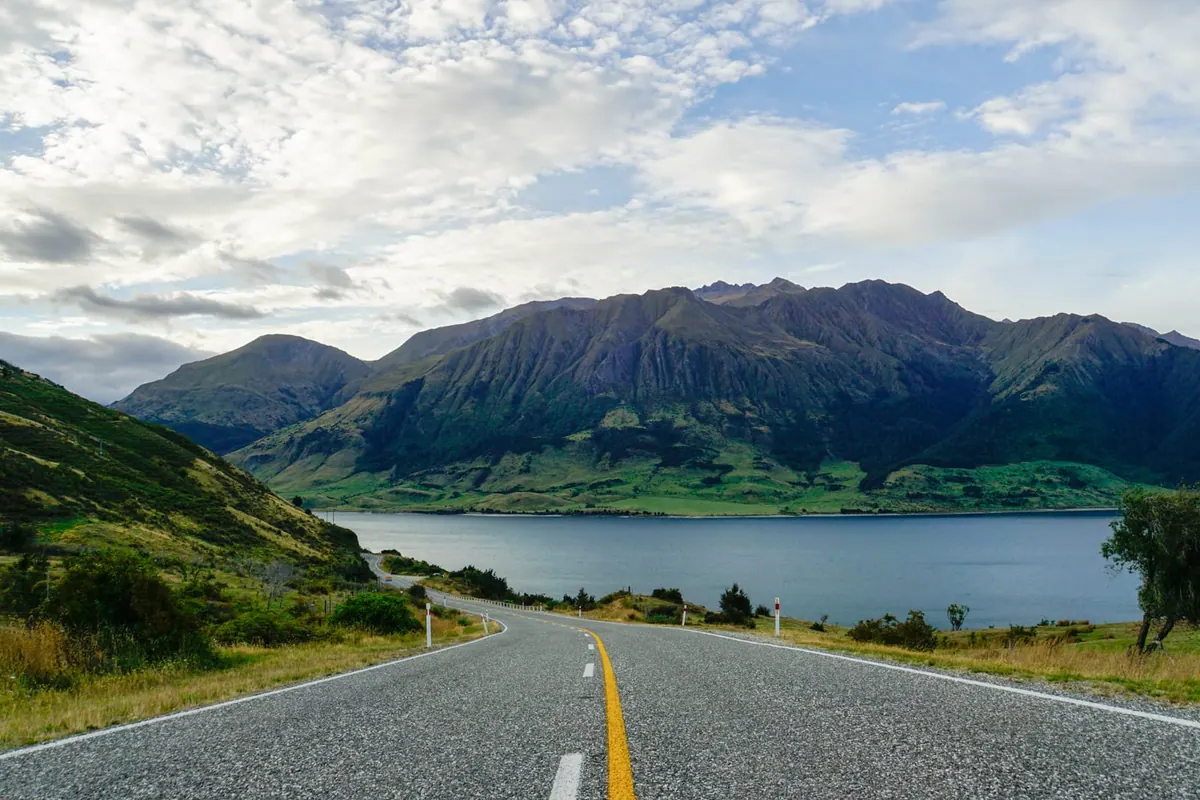Open road leading into the mountains above Lake Hāwea, New Zealand