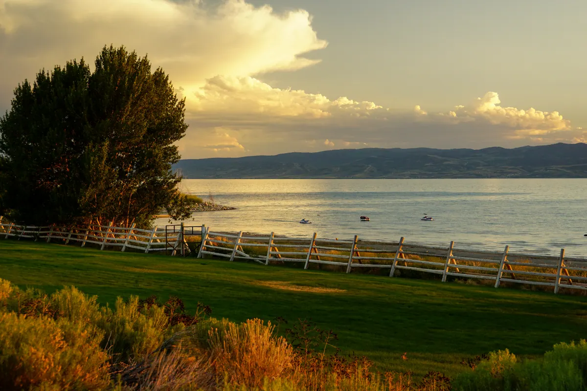 Evening light opening through clouds over the calm water of Lac Léman