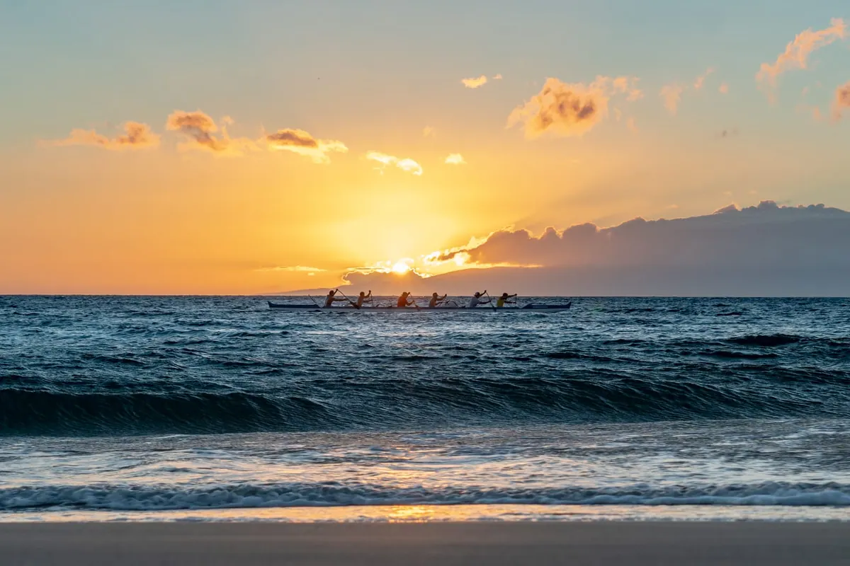 The sun sinking into the Pacific over smooth waves, Maui, Hawai‘i