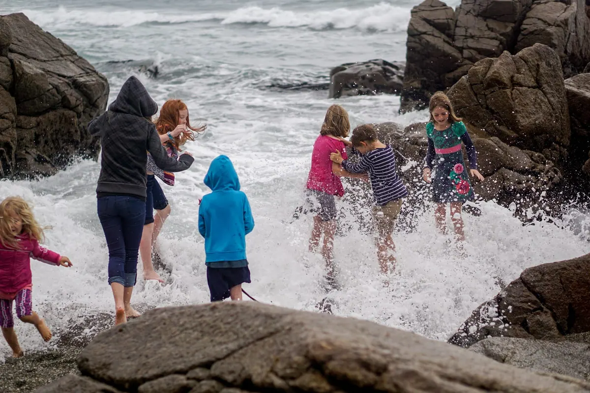 Children playing in the spray at Pancake Rocks, New Zealand