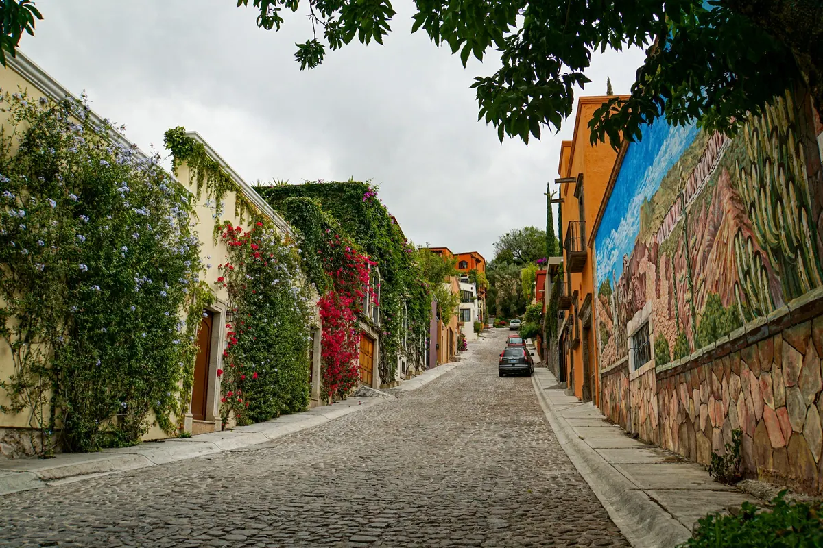 A colorful cobbled street climbing through San Miguel de Allende, Mexico