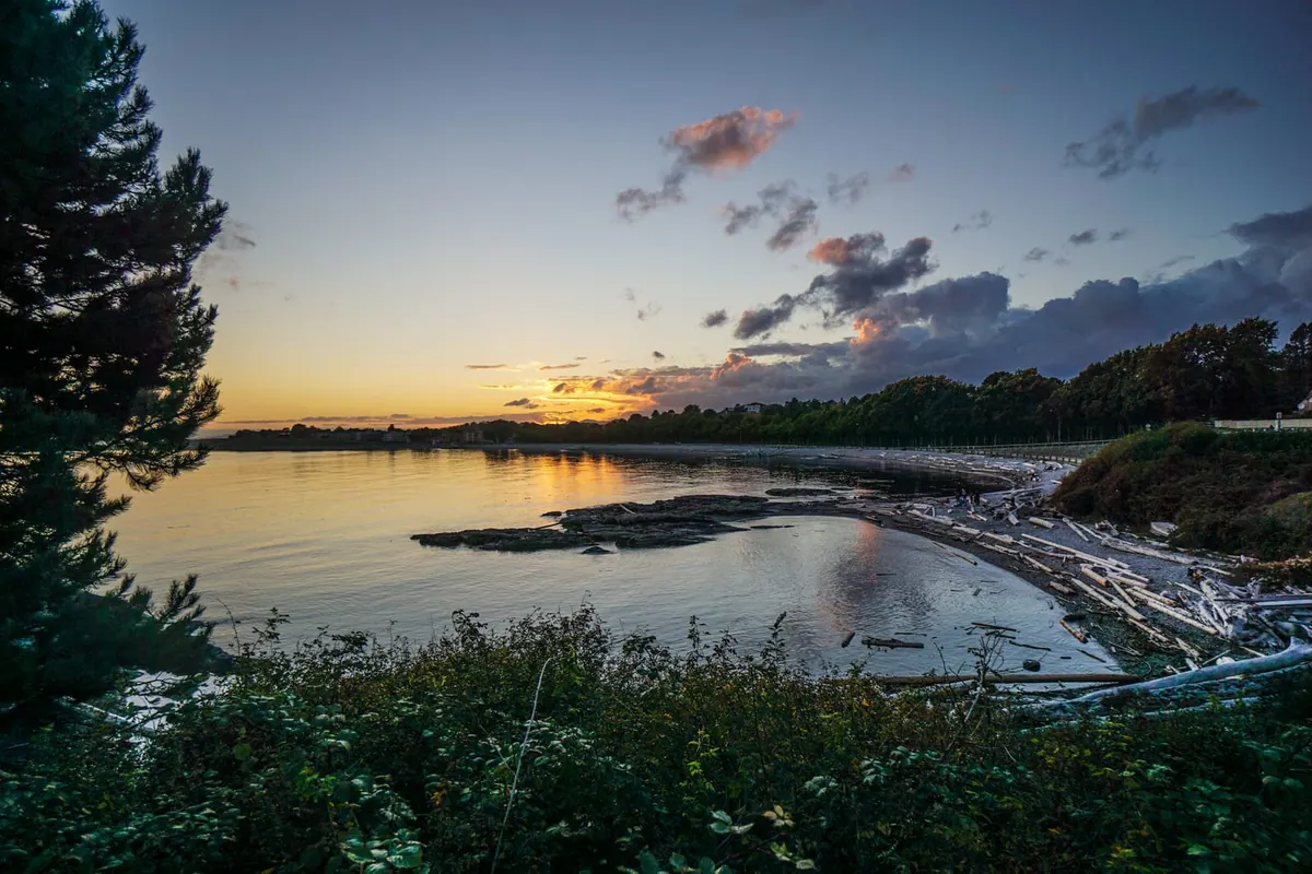 Dramatic clouds at sunset over calm water
